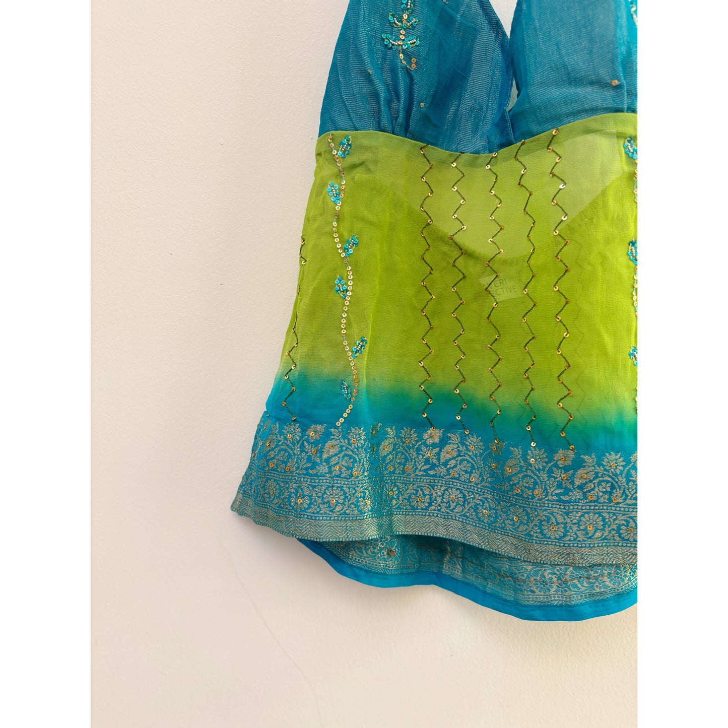 Blue green handwork top with floral border